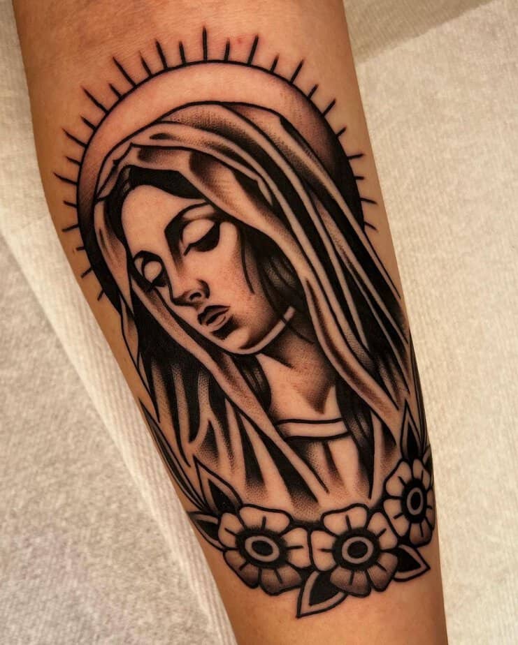 10. Bold Virgin Mary forearm tattoo