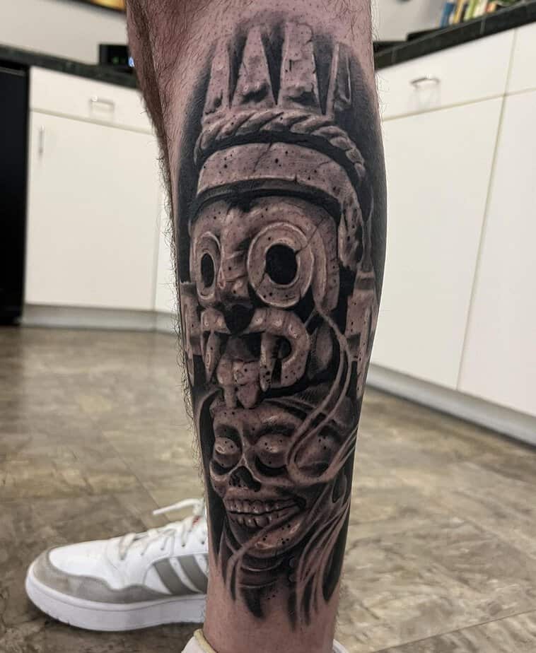 16. Striking Aztec skull leg tattoo