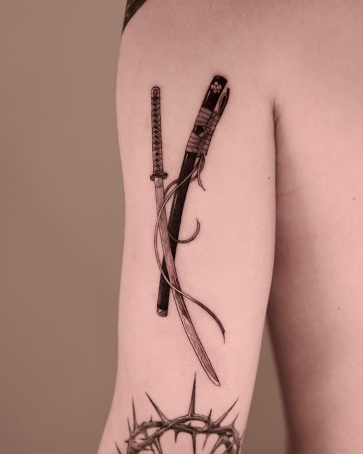 12. Un bellissimo tatuaggio con katana nera e grigia
