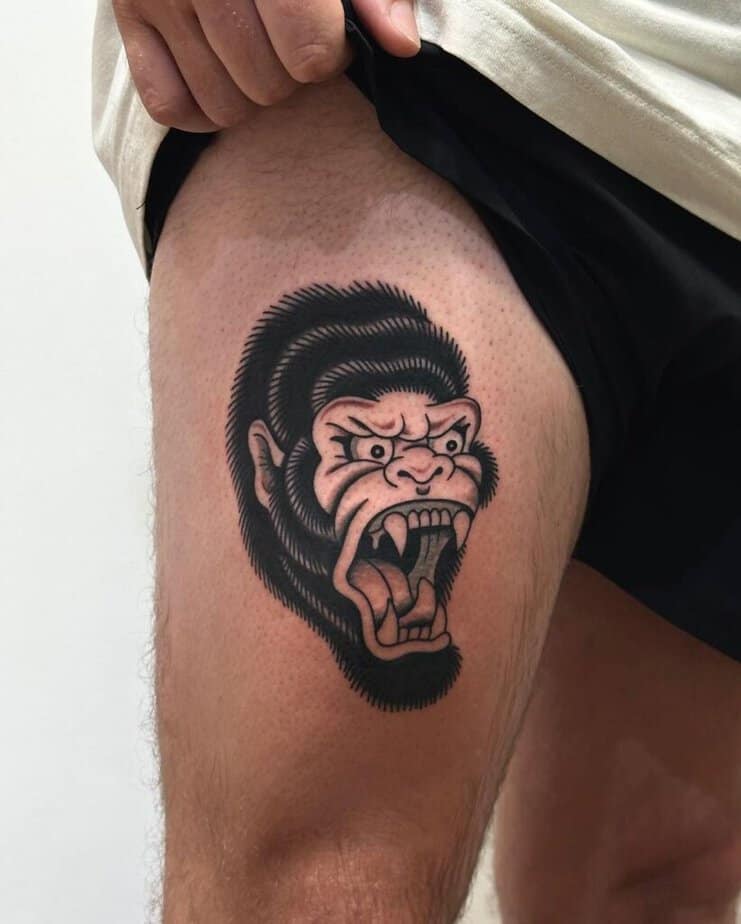 12. A tattoo of a gorilla head on the thigh