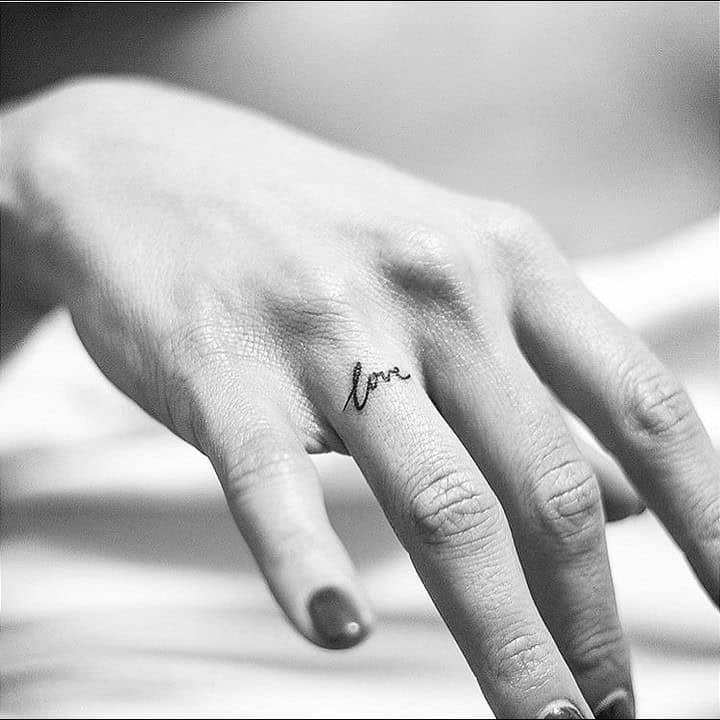 18. Minimalistic “love” tattoo