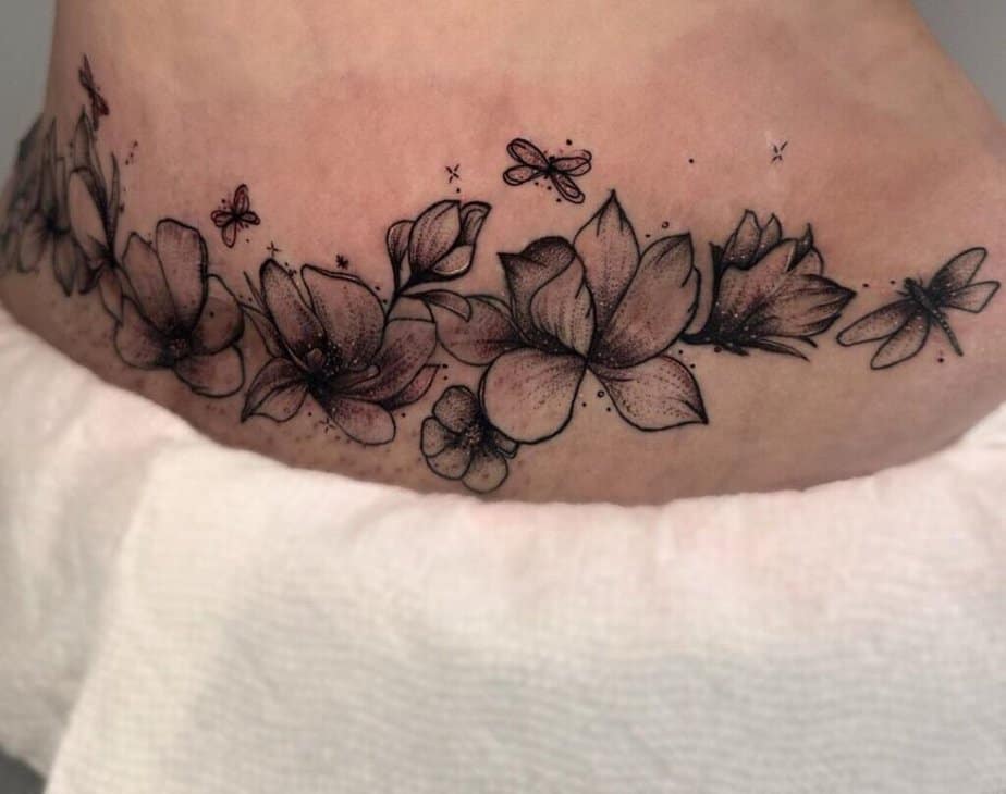 2. A tummy tuck tattoo with flowers and butterflies
