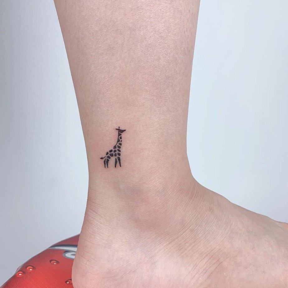 5. Black micro giraffe tattoo