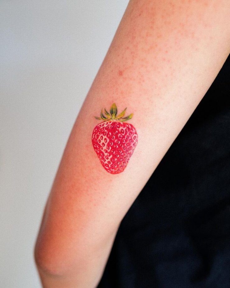 16. A strawberry tattoo on the back of the arm