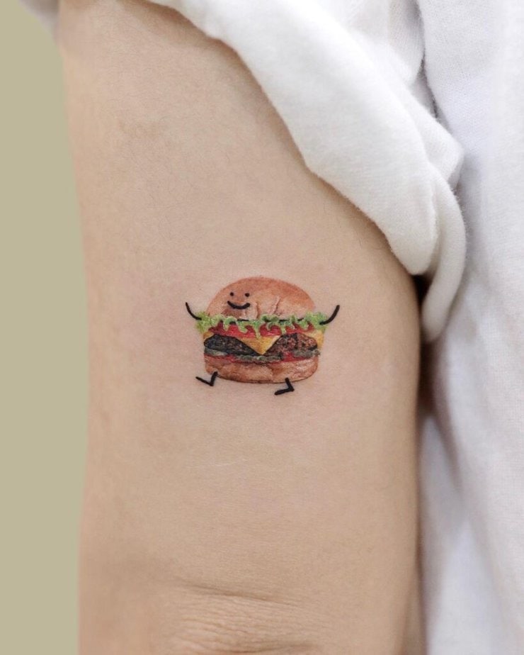 3. A happy hamburger tattoo on the back of the arm