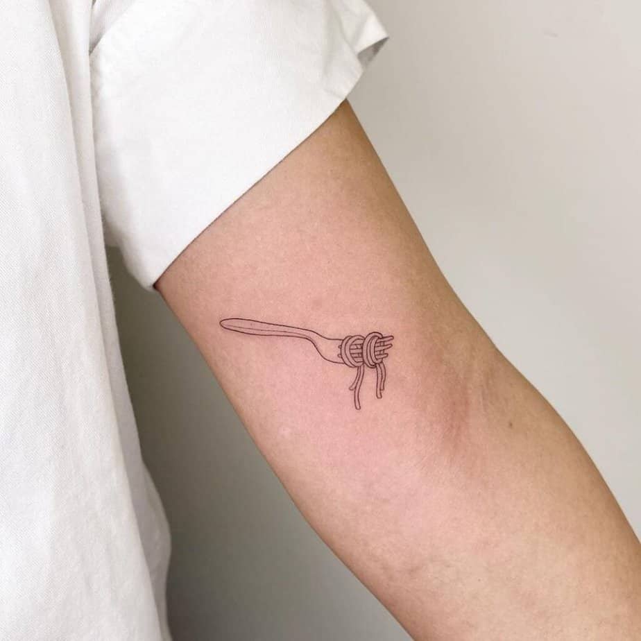 5. A linework spaghetti tattoo on the arm