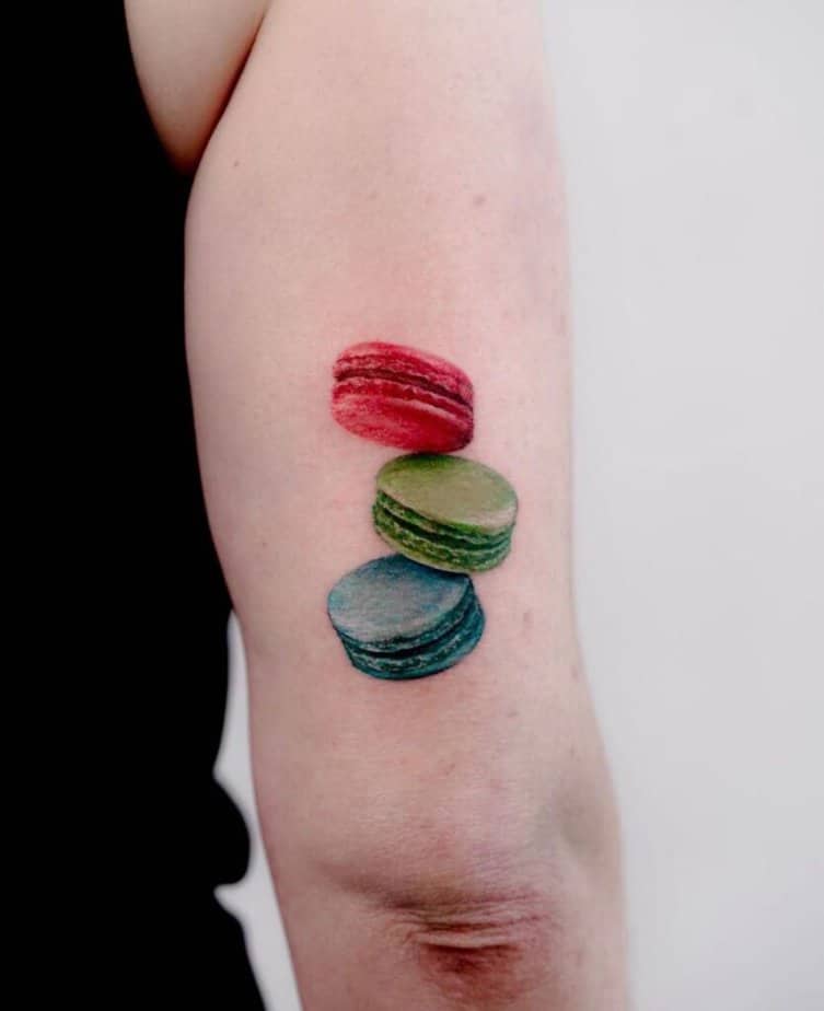9. A macaron tattoo on the back of the arm