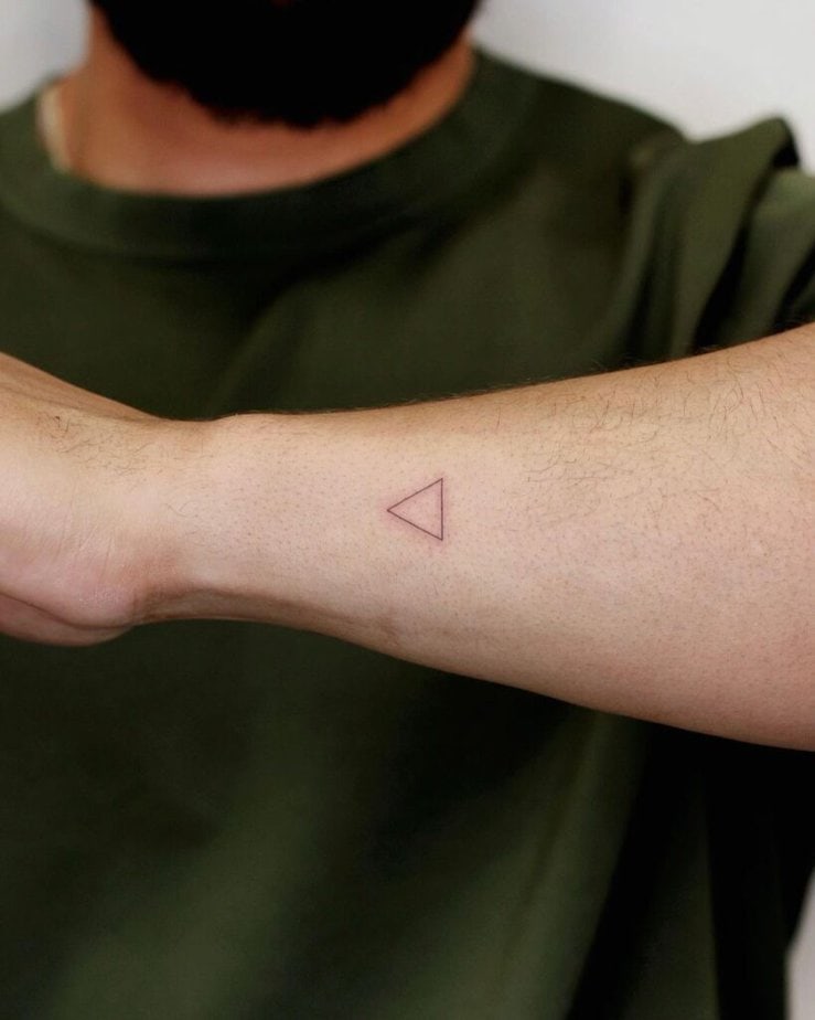 1. A tiny triangle tattoo on the side of the arm