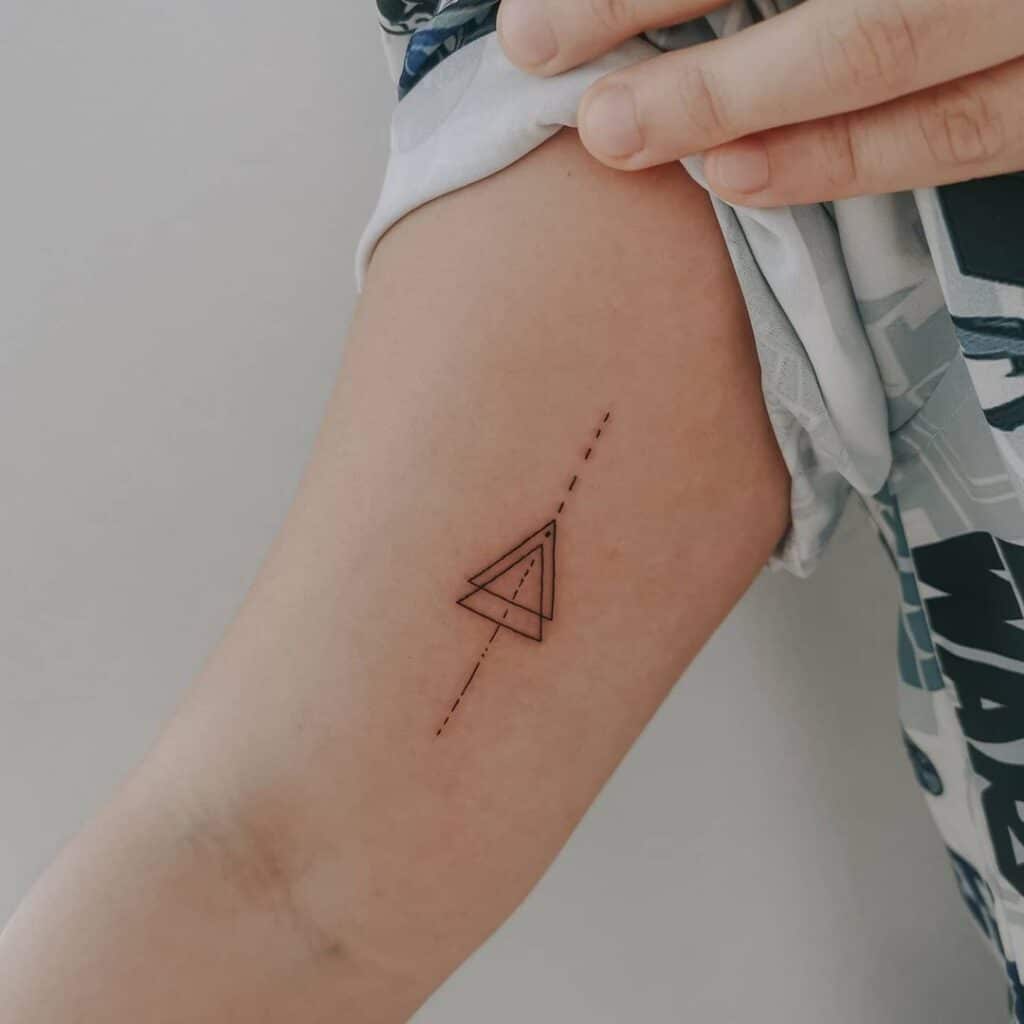 11. A geometric triangle tattoo on the inside of the arm