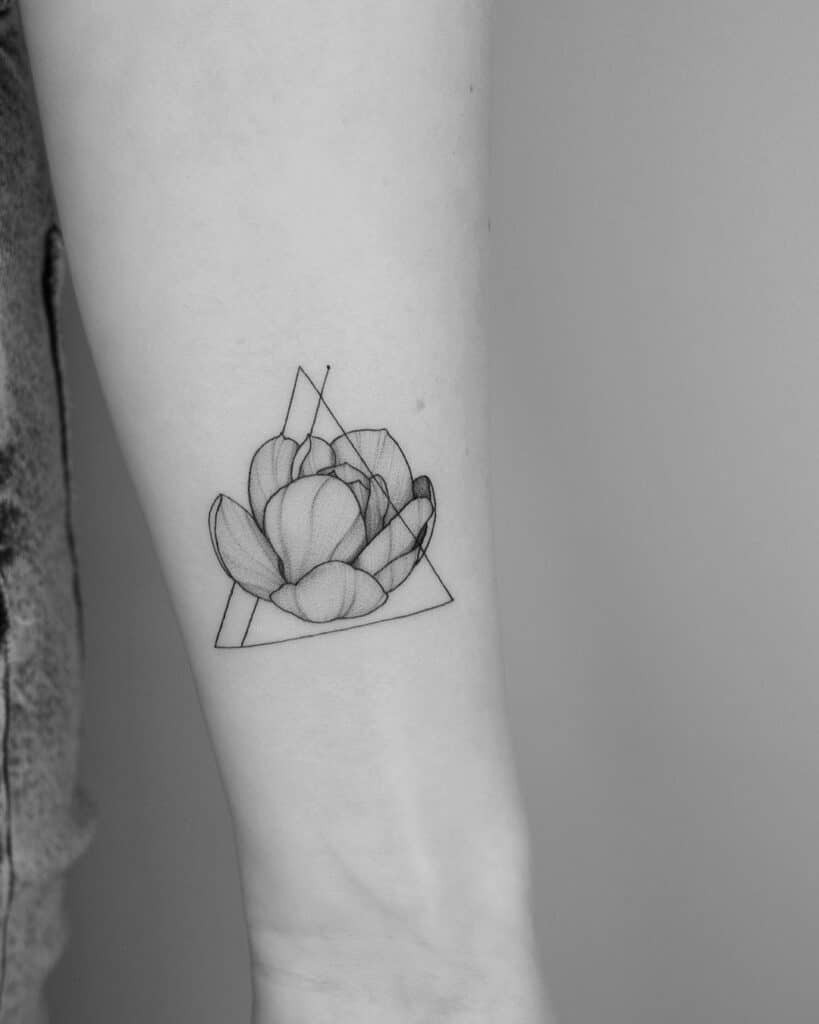 14. A magnolia triangle tattoo on the arm