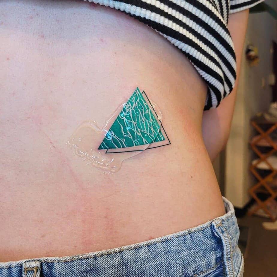 17. A wave triangle tattoo on the stomach