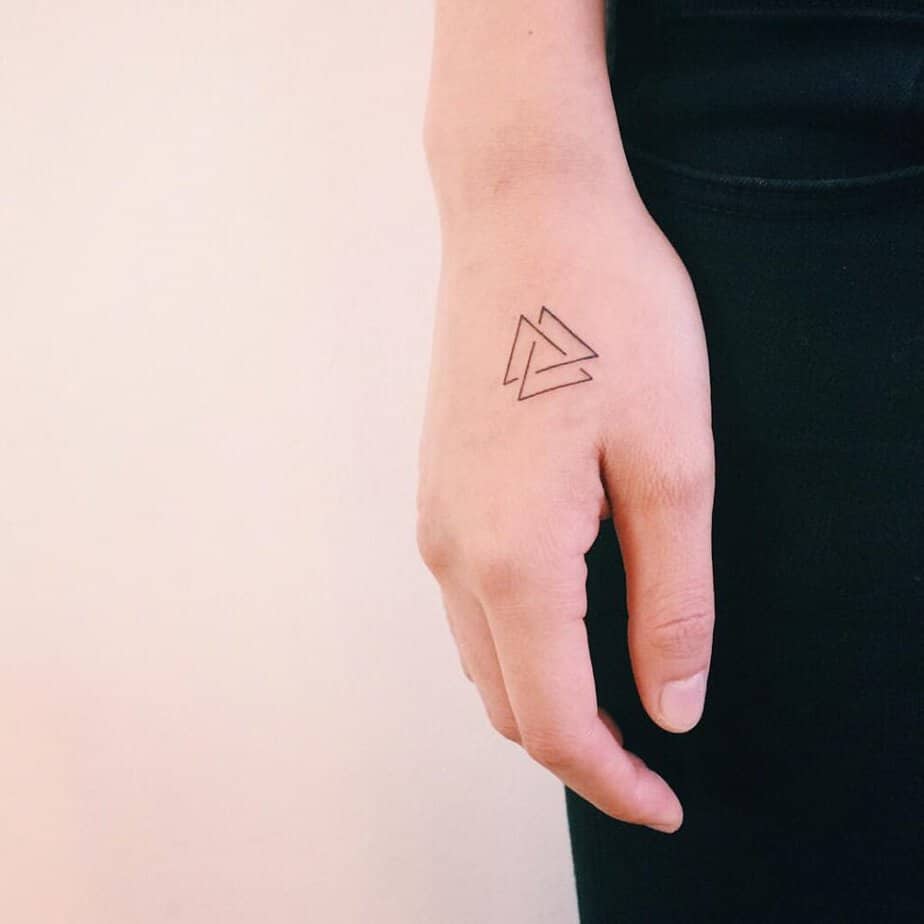19. A simple and subtle triangle tattoo on the hand