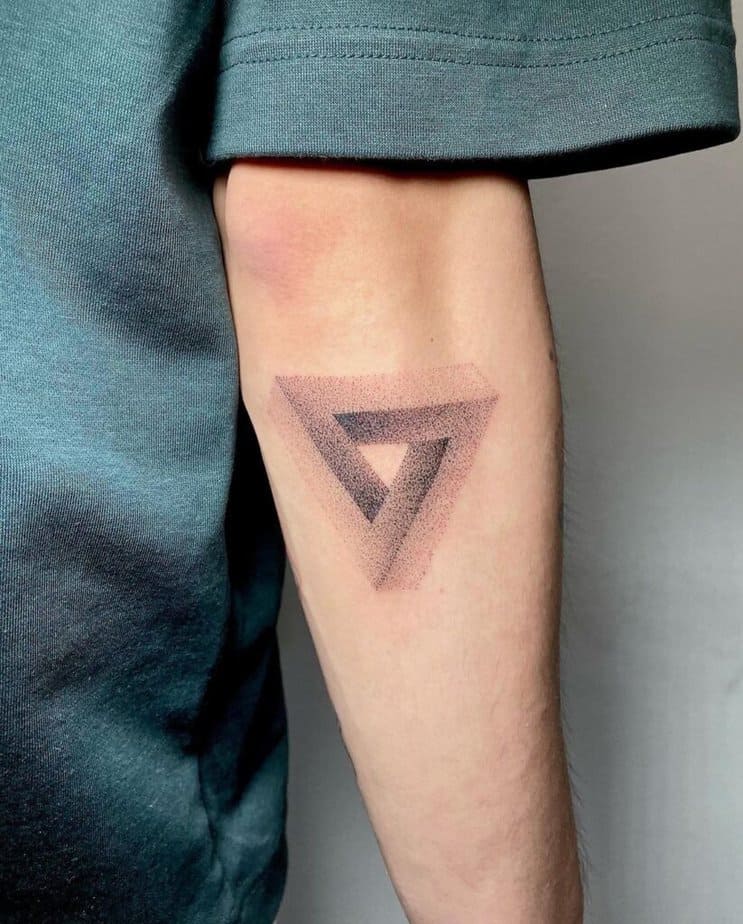 2. A dotwork triangle tattoo on the back of the arm