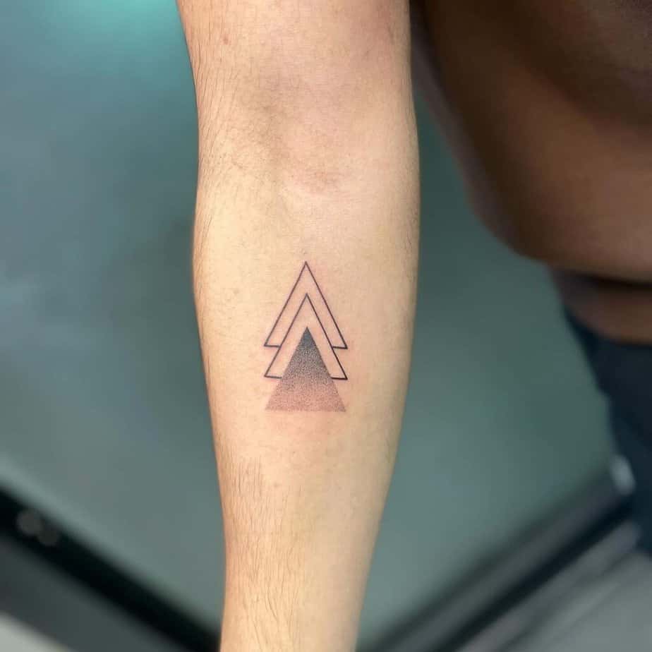 3. A tattoo of multiple triangles on the forearm