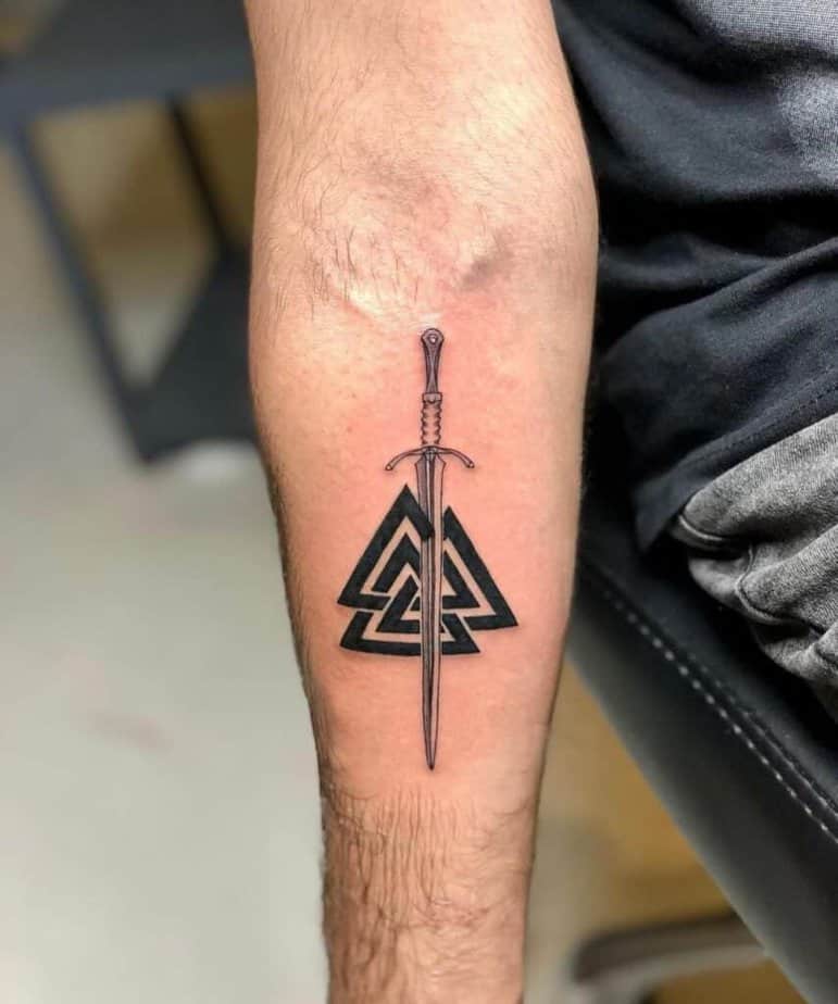 4. A tattoo of multiple triangles and a sword