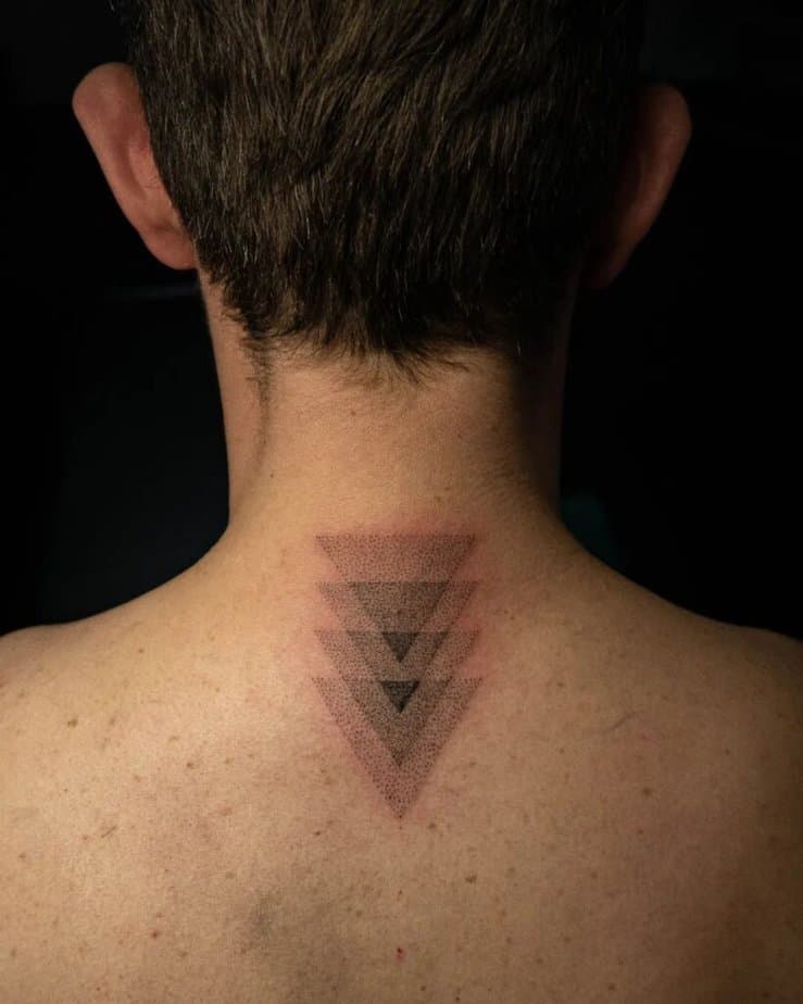8. A tattoo of multiple dotwork triangles on the back