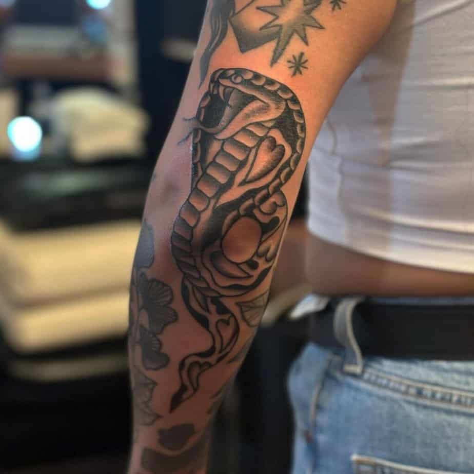 14. A cobra tattoo on the elbow 