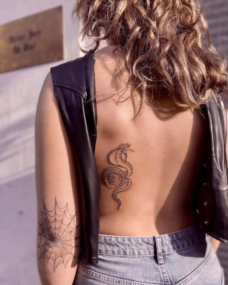 16. A tiny cobra tattoo on the back
