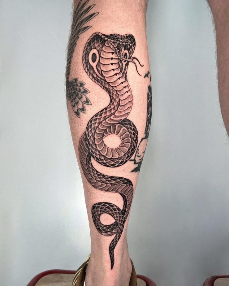 2. A cobra tattoo on the back of the leg