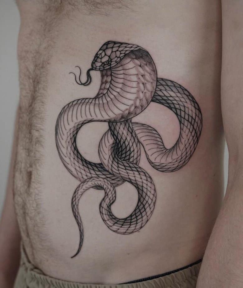 3. A cobra tattoo on the stomach