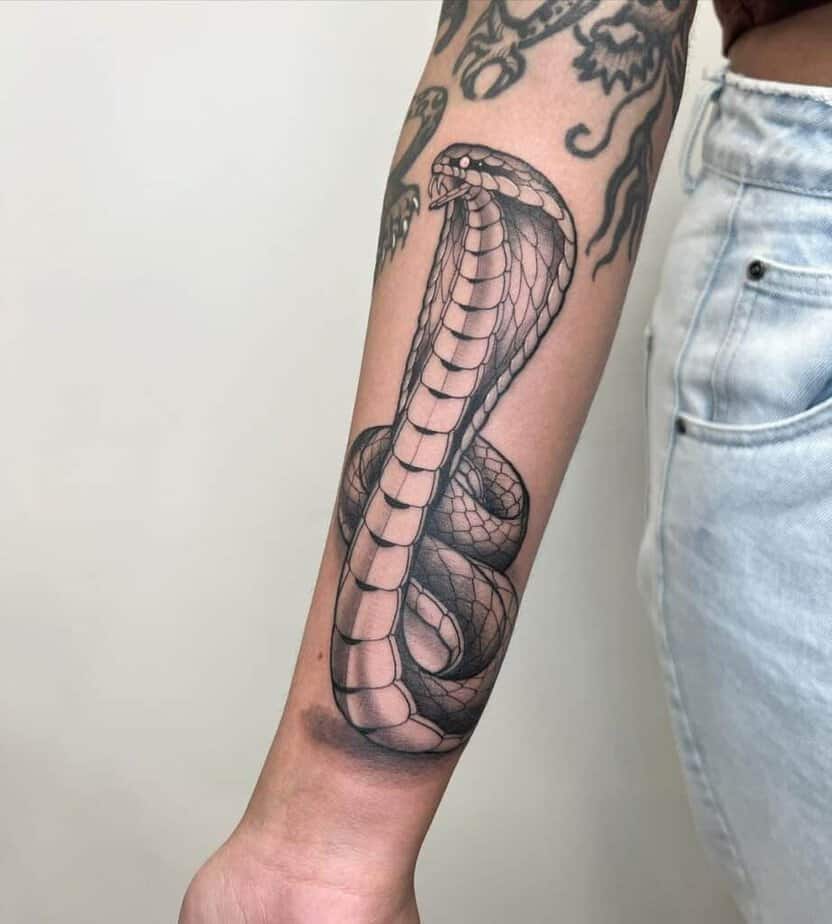 4. A cobra tattoo on the arm