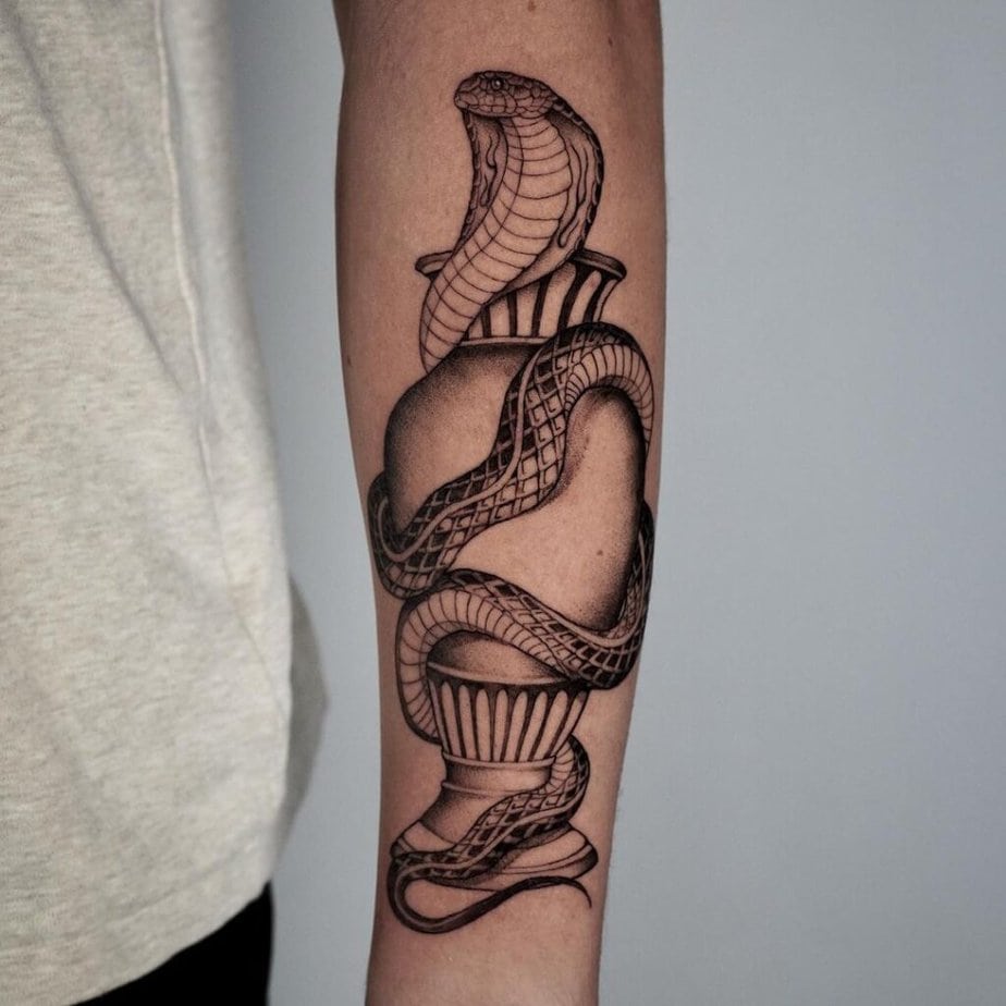 7. A tattoo of a cobra wrapped around a vase