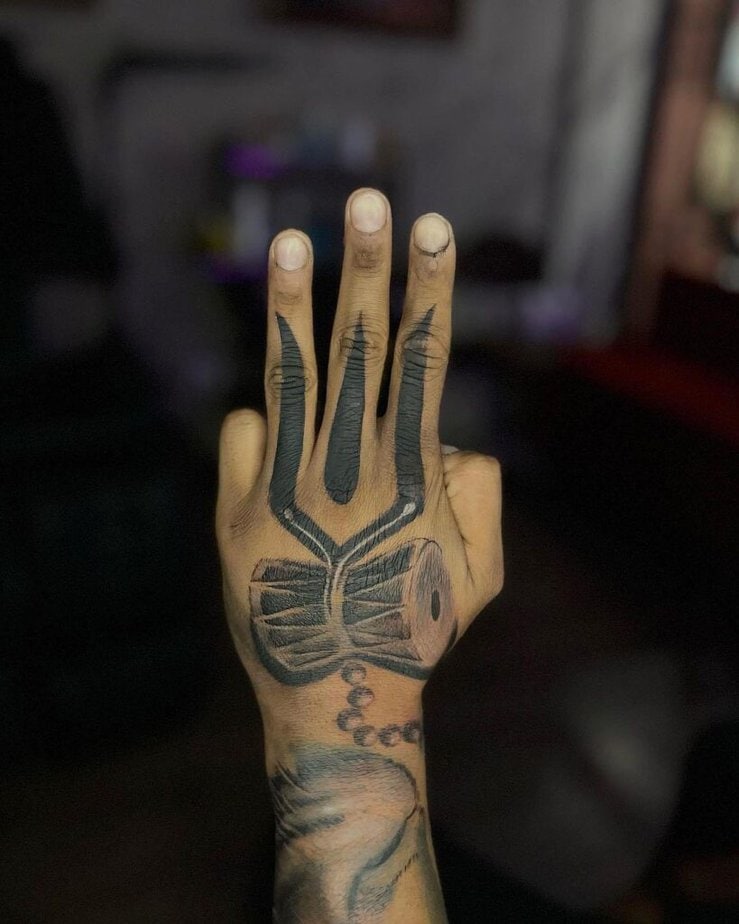 11. A tattoo of Shiva elements on the hand and fingers 