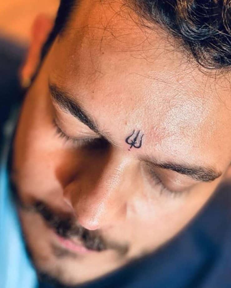 16. A Shiva tattoo on the face 