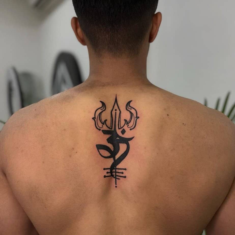 20. A blackwork Shiva tattoo on the back