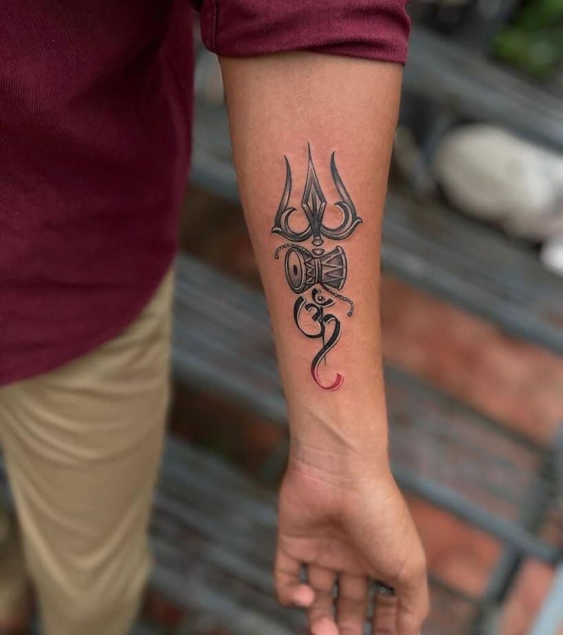 8. A tattoo of Shiva elements on the arm