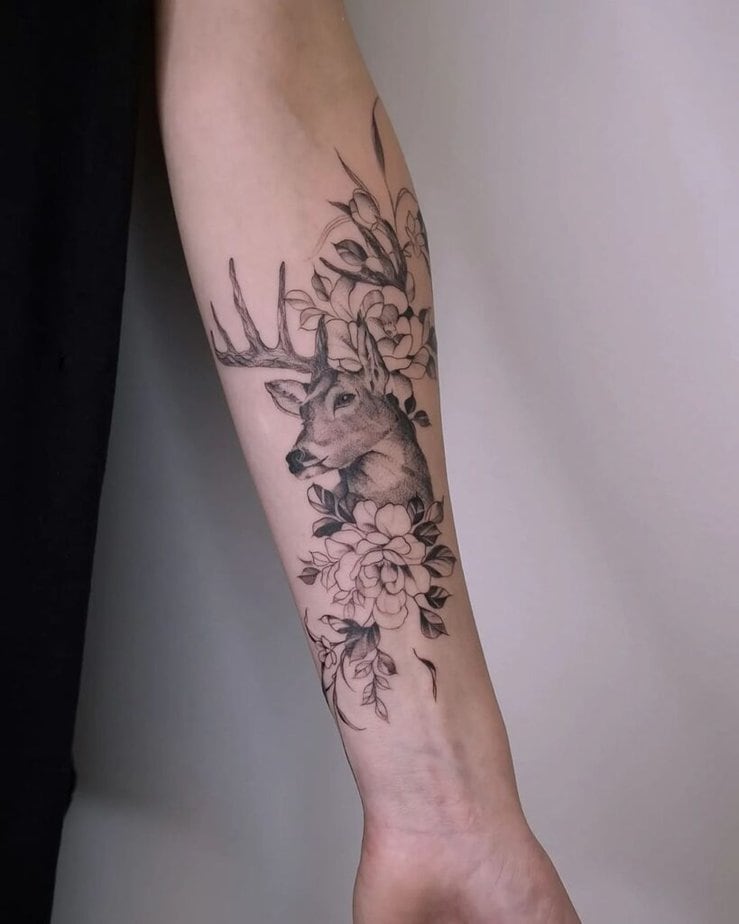 1. A tattoo of a deer surrounded by flowers 