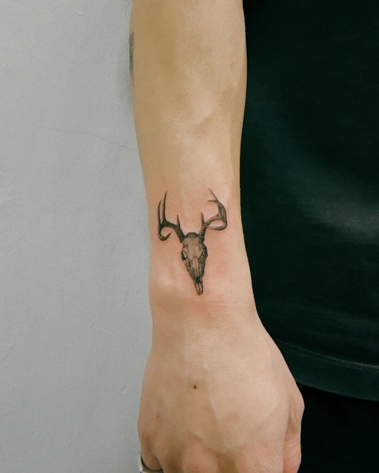 11. A tiny deer skull tattoo on the wrist