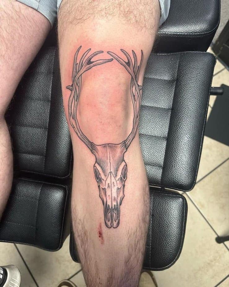 18. A deer skull tattoo on the knee