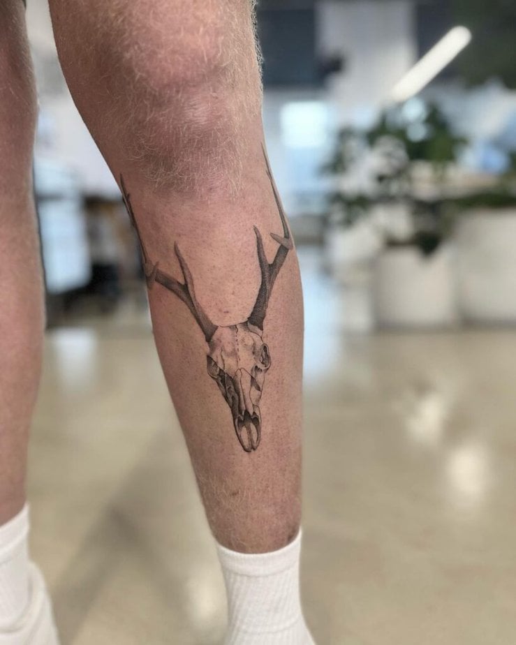 8. A deer skull tattoo on the leg