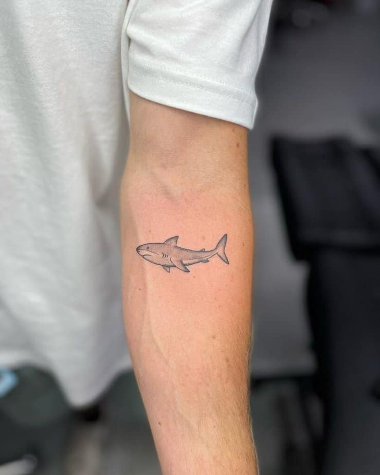 6. A black and gray shark tattoo