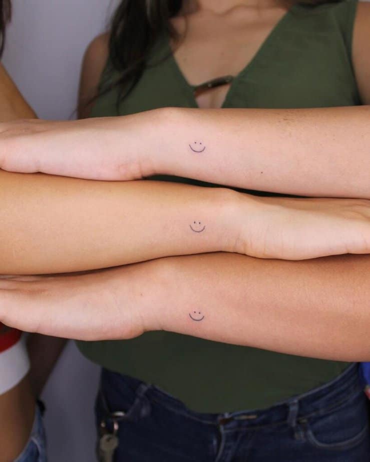 11. Matching smiley face wrist tattoos 