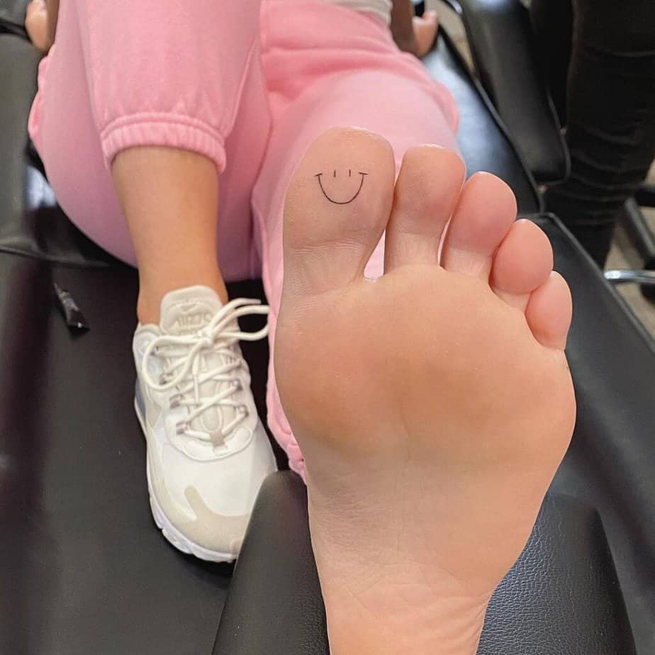 17. A smiley face toe tattoo 