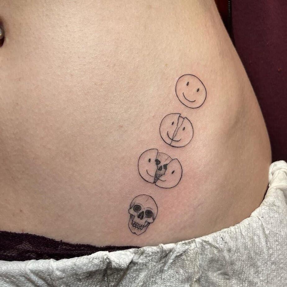 19. A tattoo of a smiley skull parade on the hip