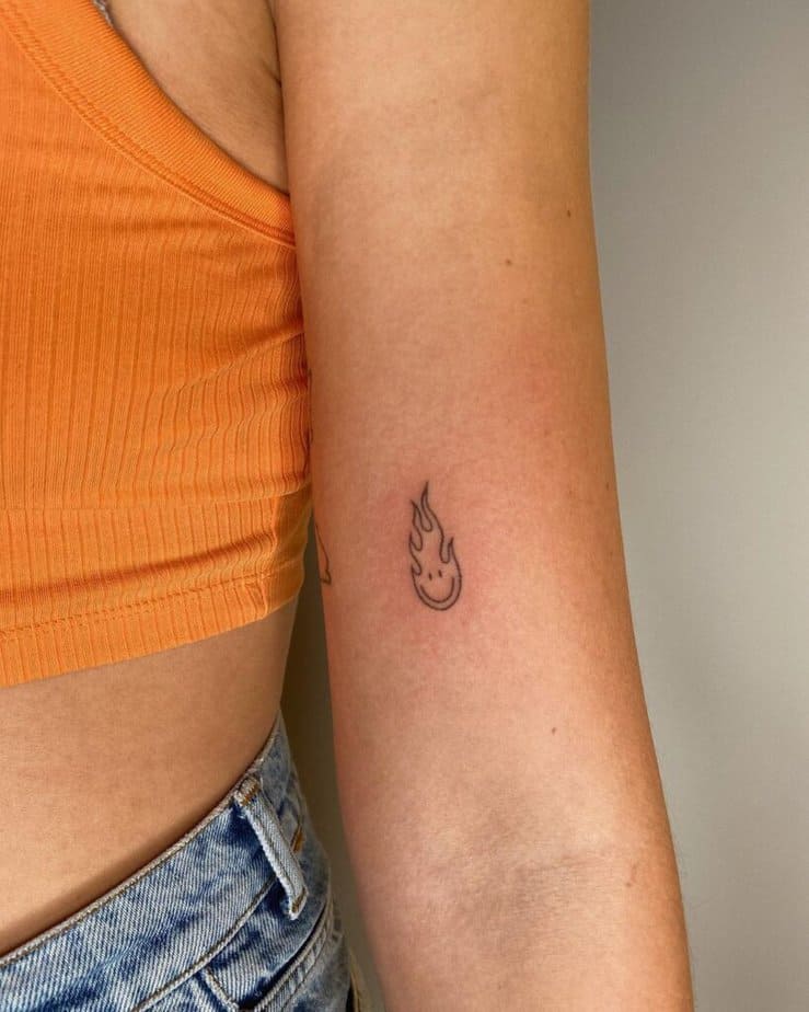 3. A smiley flame tattoo