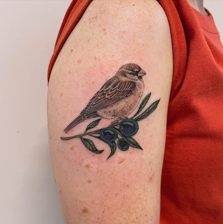 11. A tattoo of a sparrow carrying an olive branch
