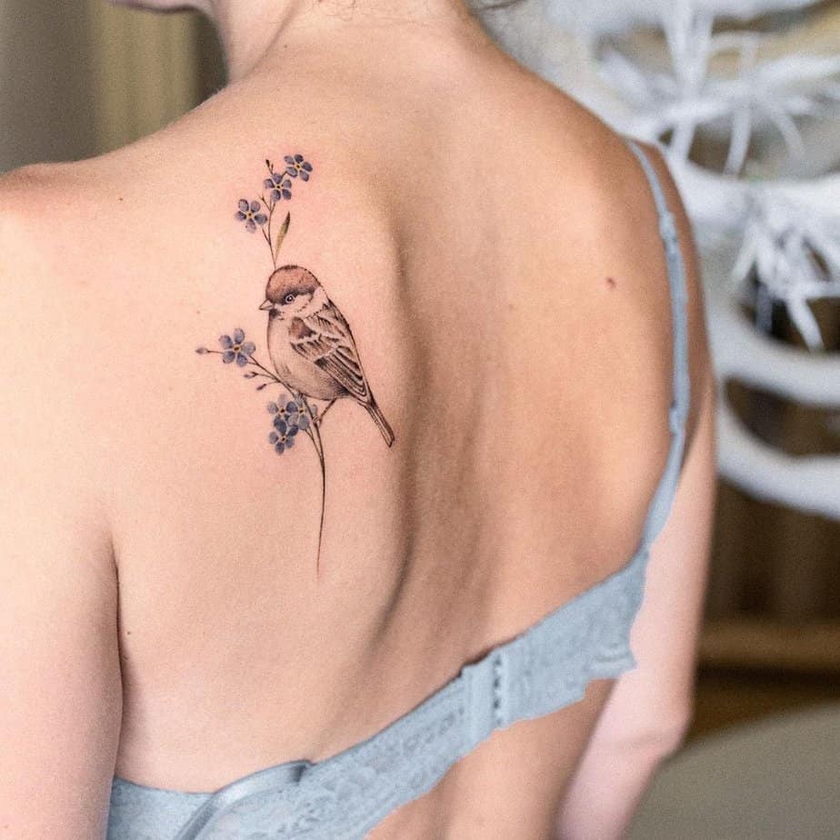 12. A sparrow tattoo on the back
