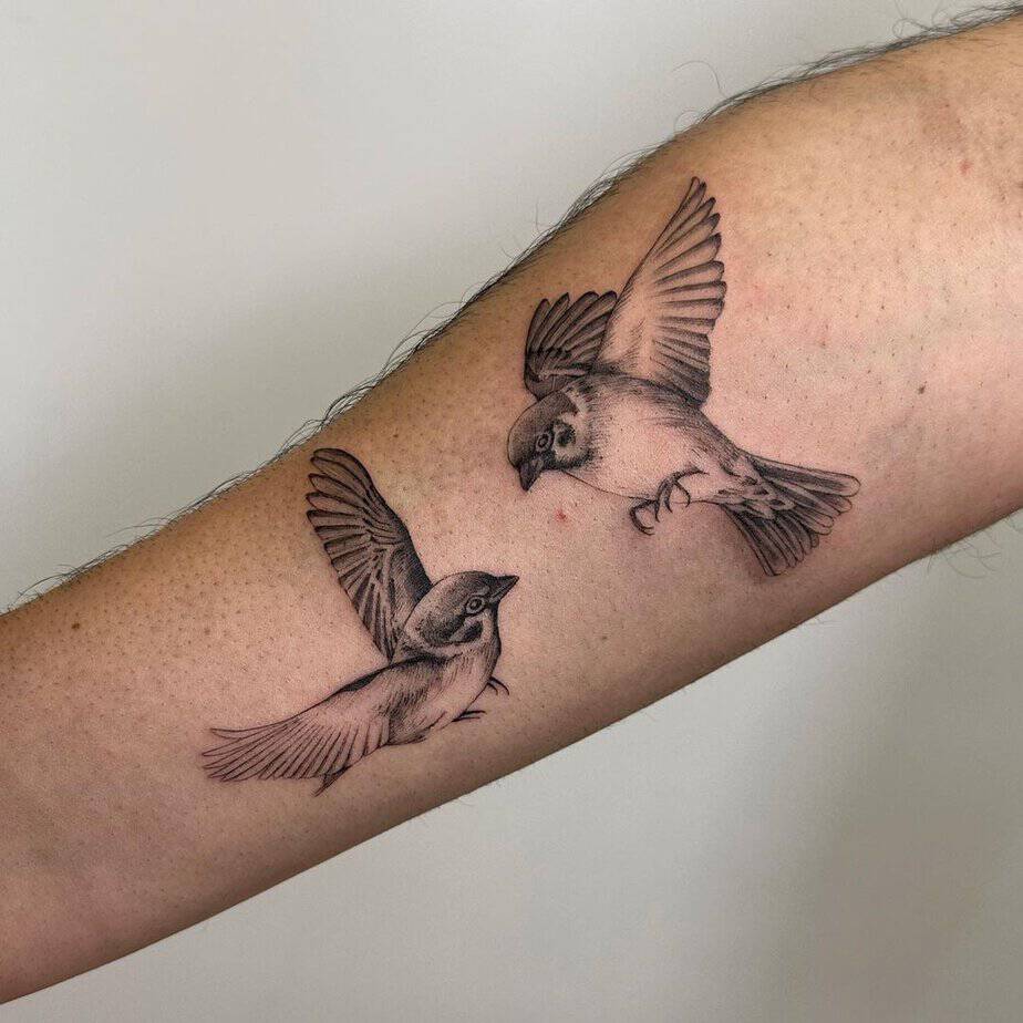 17. A tattoo of two sparrows flying toward each other
