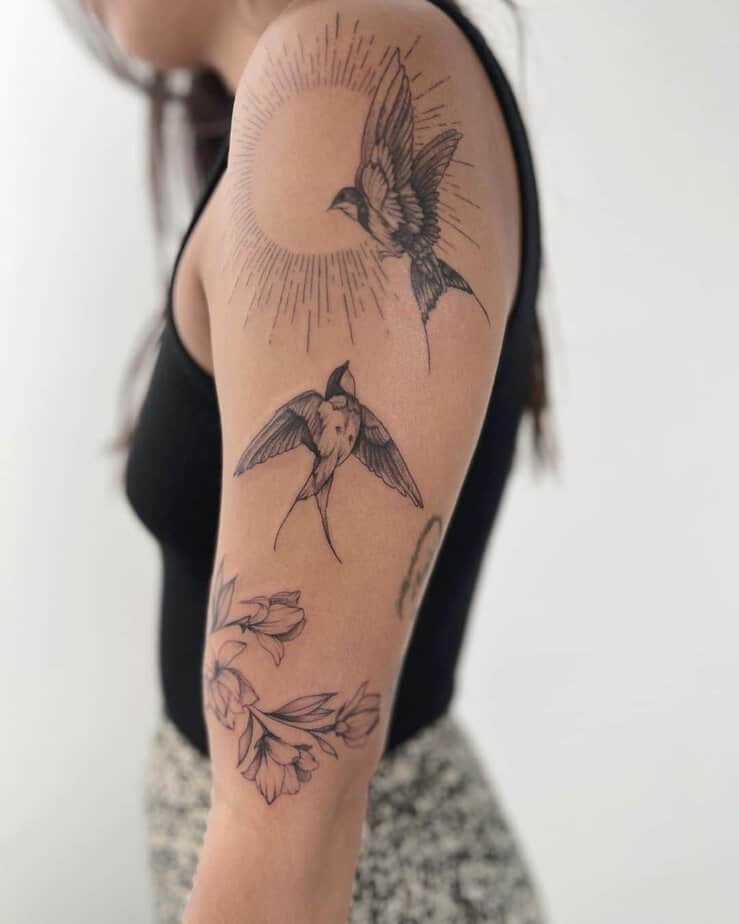 18. A sparrow tattoo with a sun
