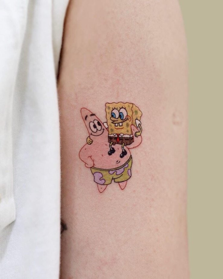 2. A tattoo of SpongeBob and Patrick on the upper arm