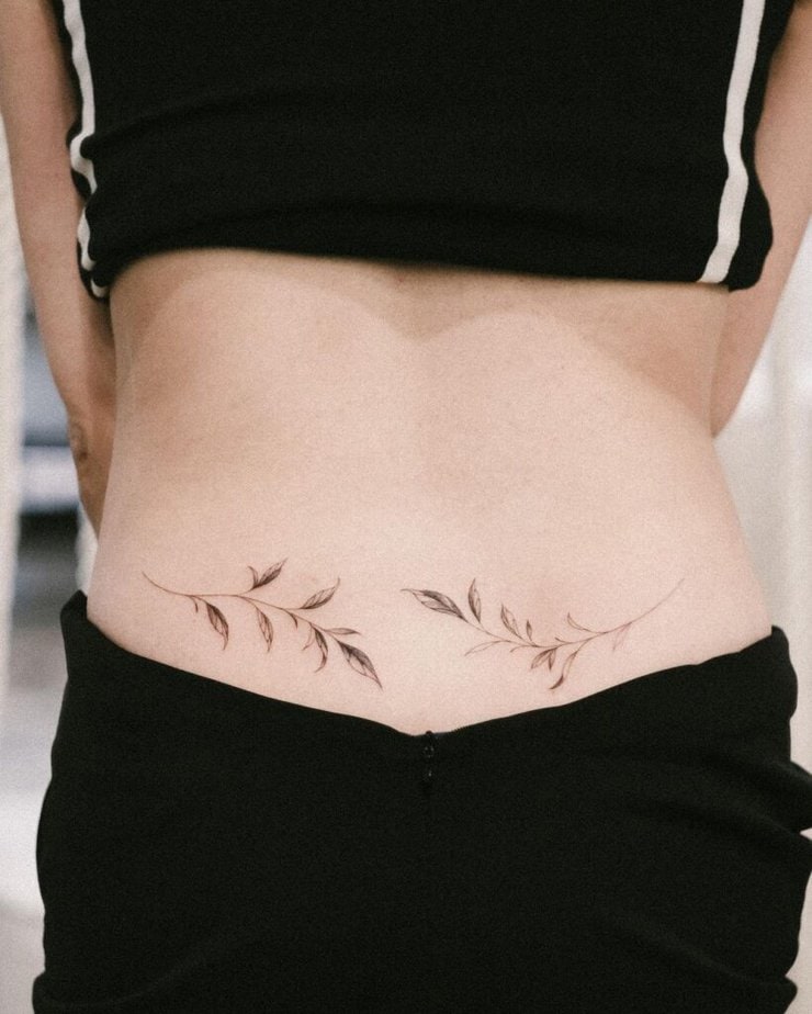 14. Botanical lower back tattoo