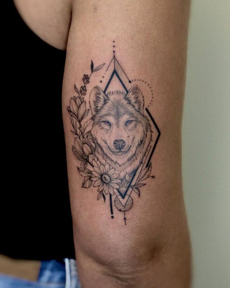 11. Geometric wolf and flowers tattoo