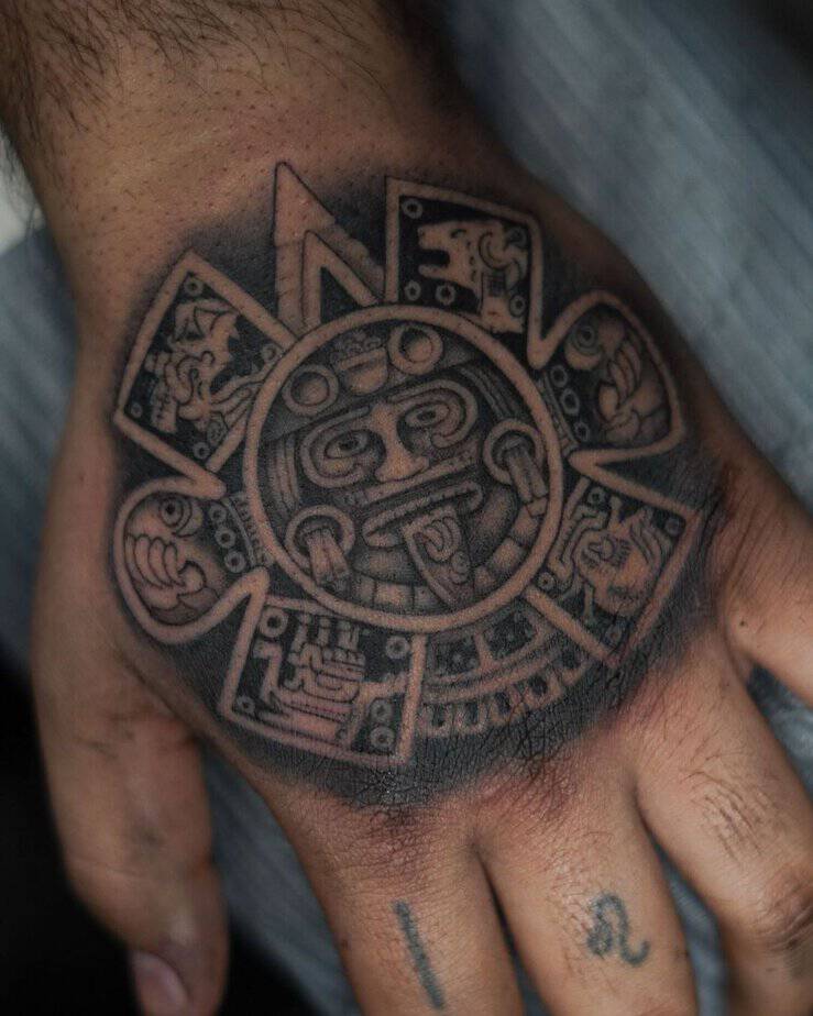 20. Detailed Aztec sun stone hand tattoo