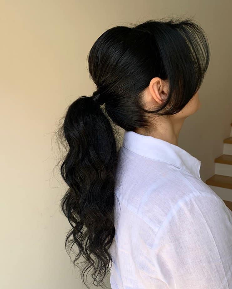 20. Wavy Ponytail with Bangs