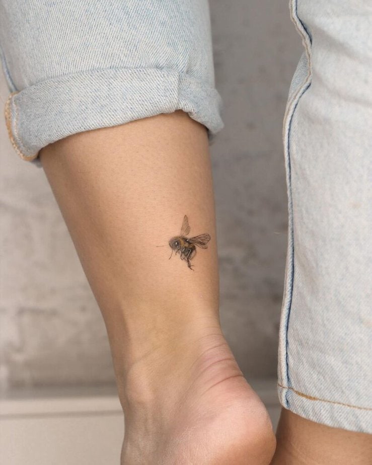 15. A bee tattoo on the back of the ankle 
