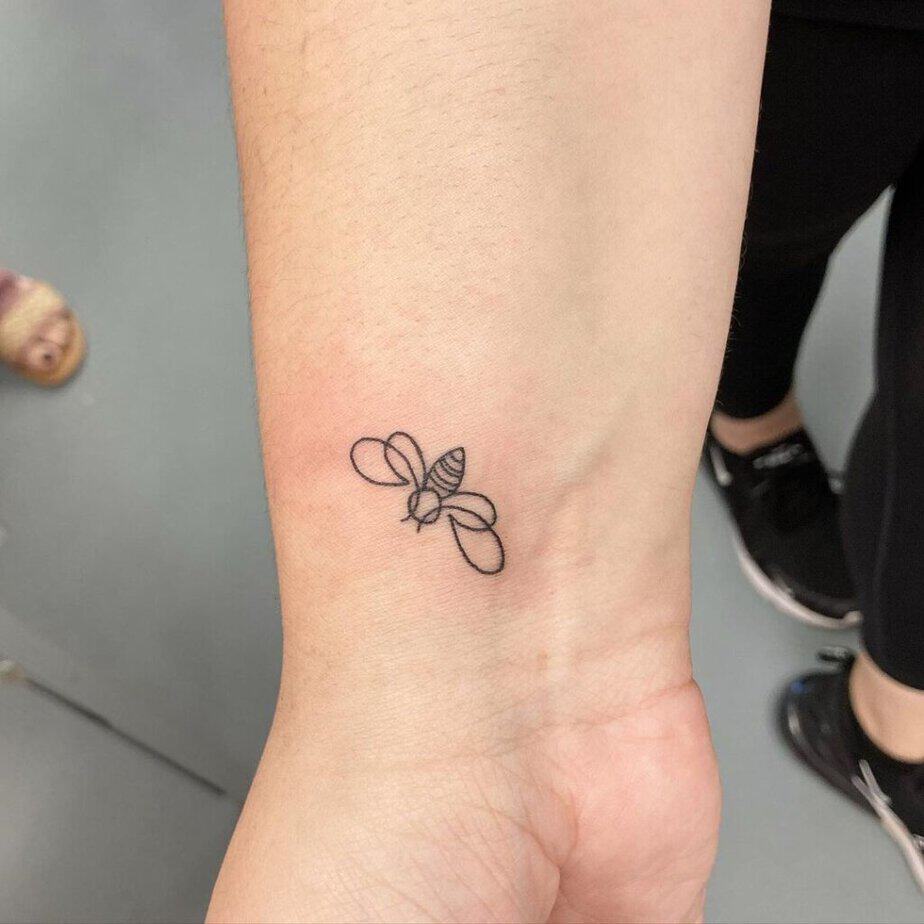 20. A line-art bee tattoo 